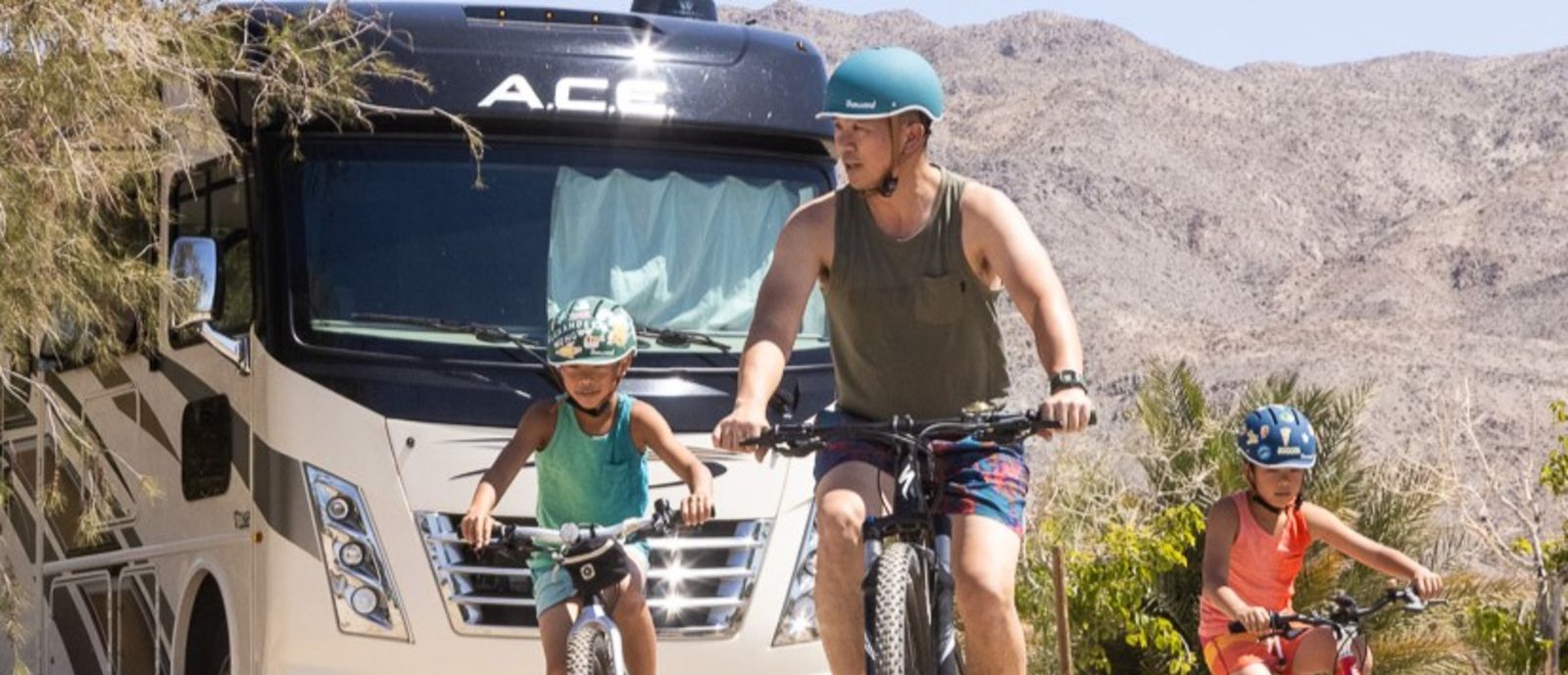 Wong family cycling in front of RV