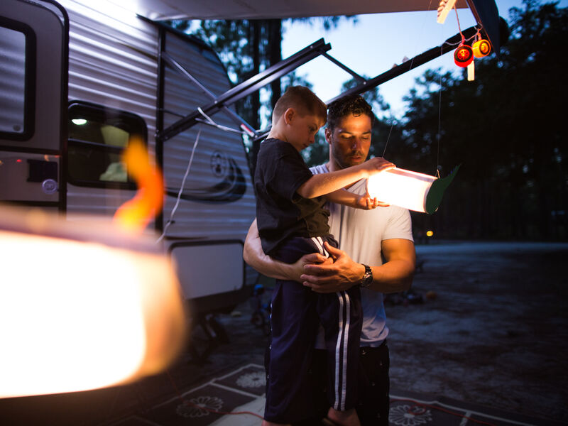 A family spends time together outside their RV
