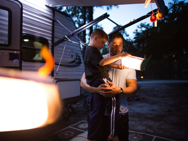 A family spends time together outside their RV
