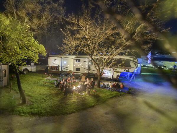 A view of an RV through the tree branches.
