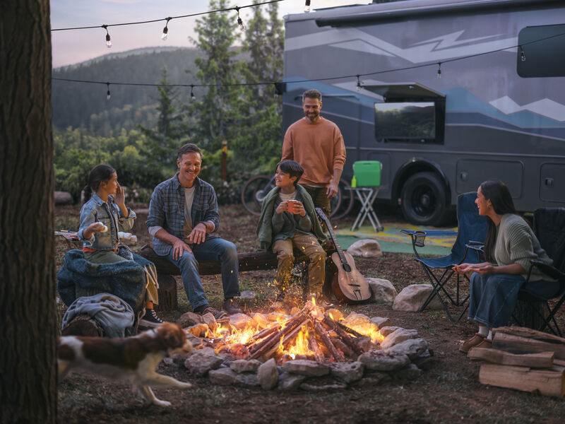 Family Around Campfire with RV