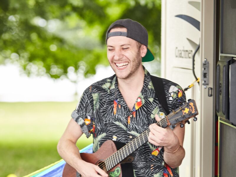 RVer plays the guitar for his companions.