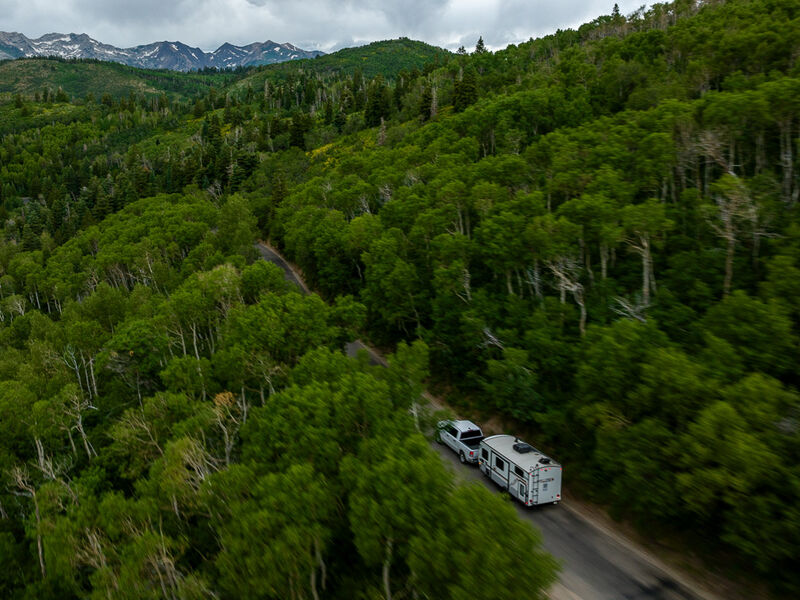 An aerial view of an RV trip towards the mountains