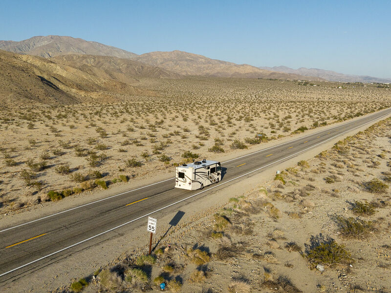 Class A motorhome driving down road