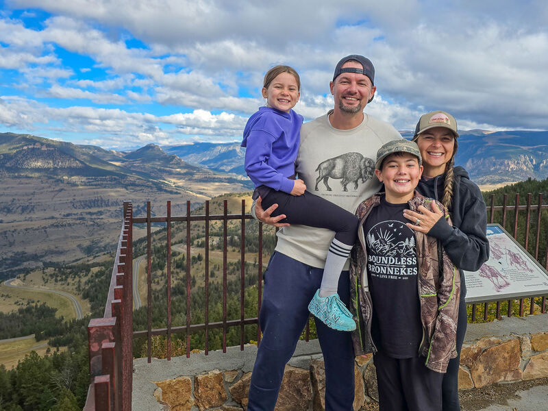 Family poses for a photo in front of mountain view