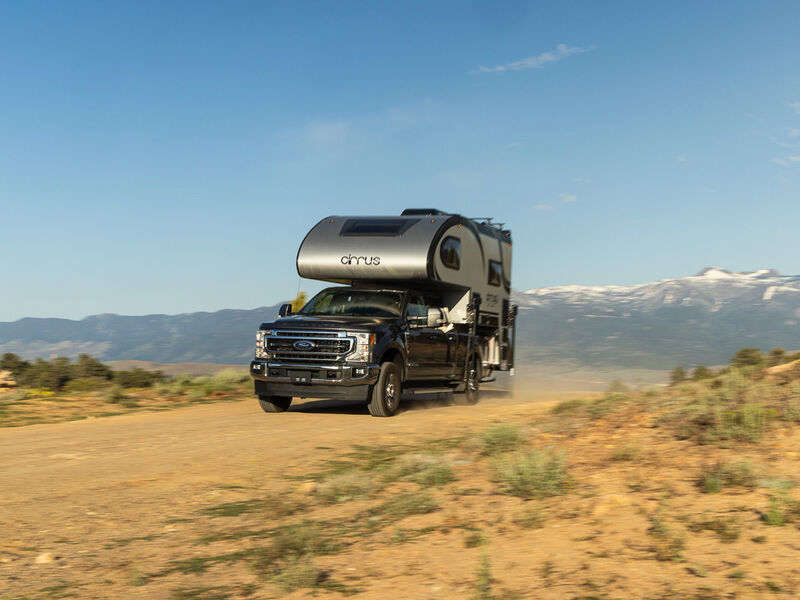 Truck camper driving across the sand