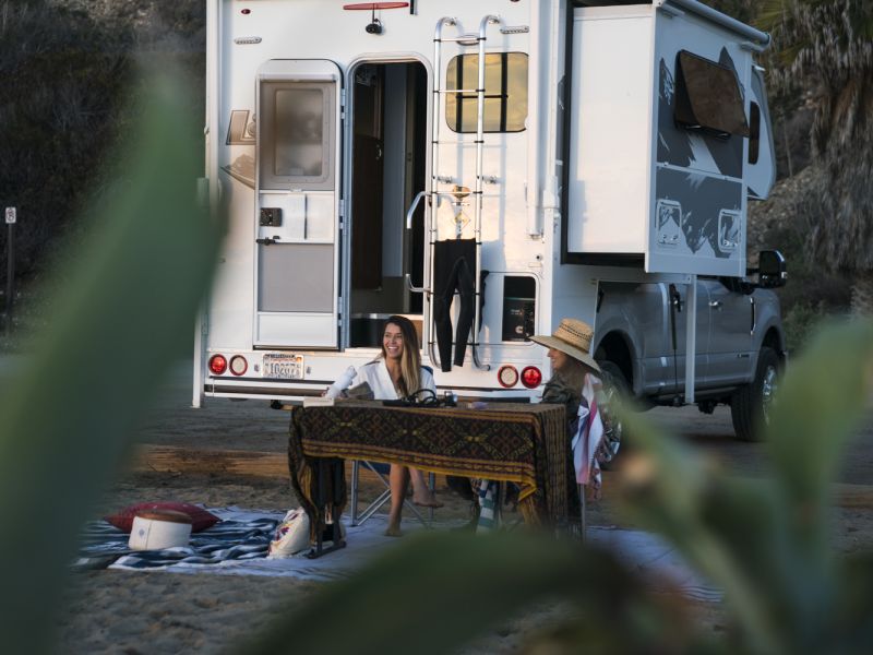 RVer enjoying the view next to their truck camper
