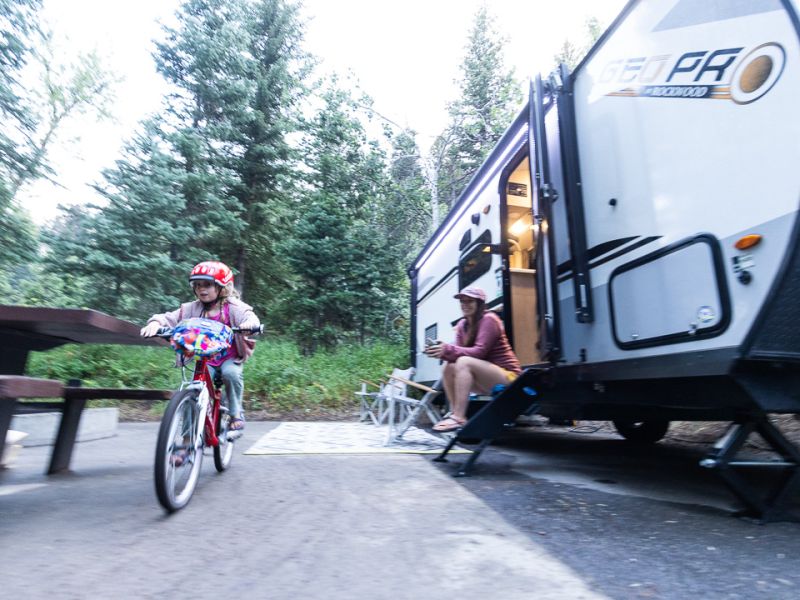 Child Biking Outside Travel Trailer
