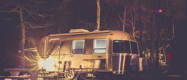 towable rv outside at night